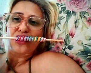 Stella Still casually sucks lollipop in blonde milf style