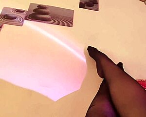 Goth beauty gives the feeling of her inked feet wearing nylons