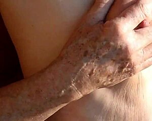 K exposes her natural tits and nipples in the calm morning nature setting.