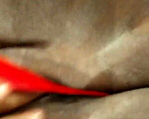 This ebony milf is masturbating with a dildo