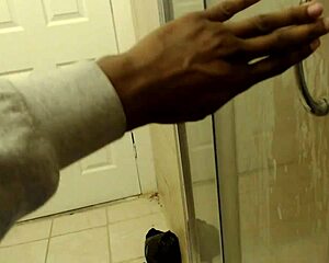 An African American woman with curves cleans up in the shower