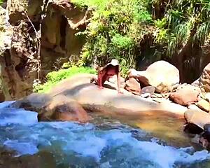 Lilyan masturbates with dildo on riverbank