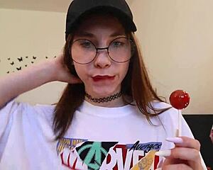 Babe is clothed and sucking hard on this candy