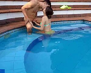 Latina chica bends over by pool with hermanastro!
