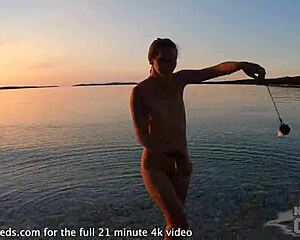 Nude fire dancing on the beach at sunset