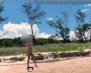 Young beauty shows off her body at a public beach