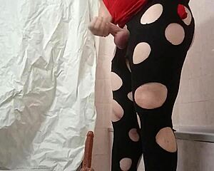 A travesti plays with a dildo in a fun way