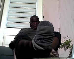 bear black master shows off big feet after work, looking for a slave to serve