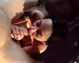 In the steamy jacuzzi, she sucks her man's big cock deepthroat style