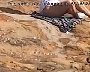 Linda novinha caught having sex publicly on beach rocks. Third guy interrupts her doggystyle moment!