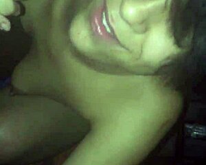 Latina amateur giving a blowjob to a black cock at home