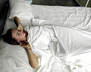 Young brunette teen with short hair masturbates by fingering her slit in bed at home