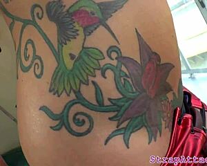 Alluring tattooed domina fingers her boyfriend with strapon domination