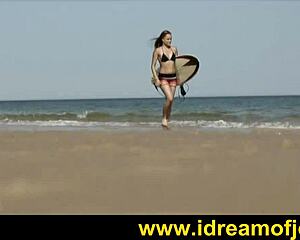 Brunette surfer on beach engages in subtle solo fingering and masturbation