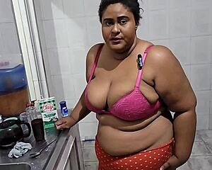 the stepmother is getting fucked in the kitchen by her stepson and receiving a lot of cum