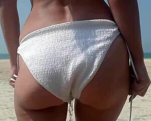 fat woman in white bikini pees on public beach