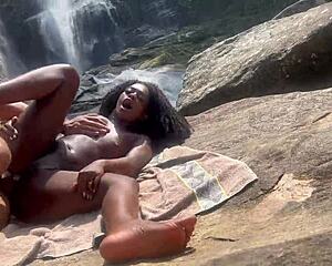 Ebony goddess giving her little pussy in public at the waterfall