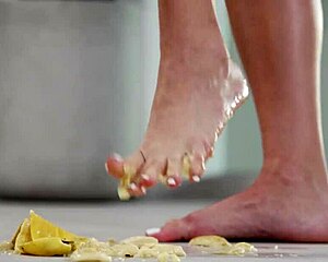 This 4K footfetish video features crushing fruits with bare feet and high heels