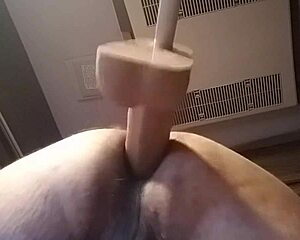 Solo play with a large dildo in doggy style position