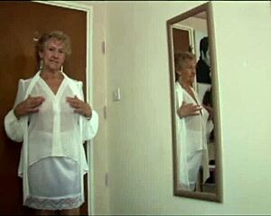 naughty granny in see-through top and slip, wanna peek at her teasing upskirt?