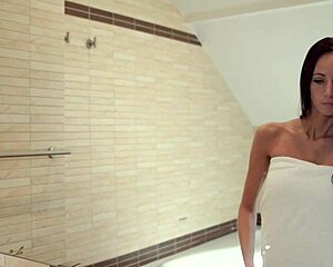 Brunette Eveline relaxes in the bathroom