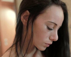 Brunette Eveline relaxes in the bathroom