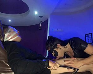 The dominatrix gives a secret blowjob in part one.