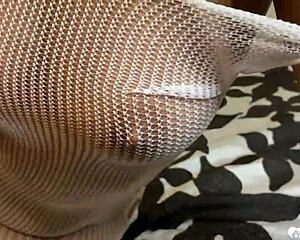 Brunette in fishnets playing with her slit?