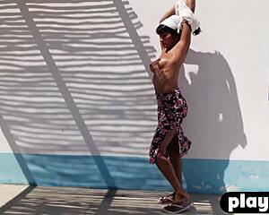 Stunning petite Asian milf Angel Constance strips showing ass and natural tits