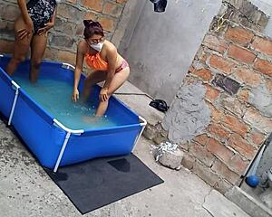 athletic indian babe and curvy latina soak up sun by pool