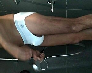 shaved guy showers and strokes his hard cock close up