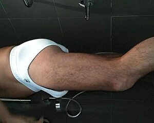 shaved guy showers and strokes his hard cock close up