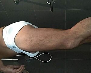 shaved guy showers and strokes his hard cock close up