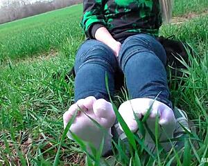 goddess spreads toes in white socks jeans on grass
