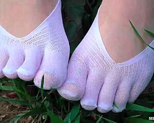 goddess spreads toes in white socks jeans on grass