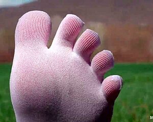 goddess spreads toes in white socks jeans on grass