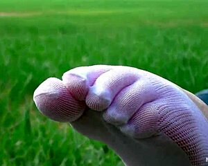 goddess spreads toes in white socks jeans on grass