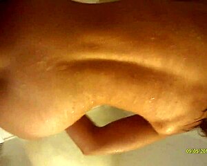 A husband and wife share a sensual early morning shower routine.