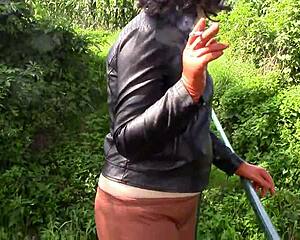smoking milf in tight cinnamon leather trousers gloves outdoor fetish tease