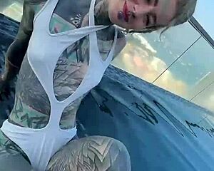 bikini model with feettattoo lounges by pattaya rooftop pool