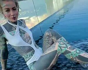 bikini model with feettattoo lounges by pattaya rooftop pool