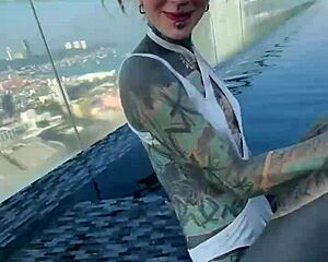 bikini model with feettattoo lounges by pattaya rooftop pool