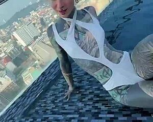 bikini model with feettattoo lounges by pattaya rooftop pool