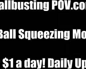 Femdom mistress kicks submissive's balls repeatedly in BDSM fetish play