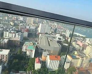 bikini model with feettattoo lounges by pattaya rooftop pool