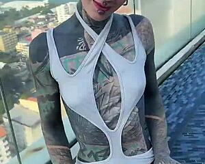 bikini model with feettattoo lounges by pattaya rooftop pool