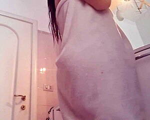 hot blonde bombshell strips naked in bathroom showing off big ass natural tits and wet pussy