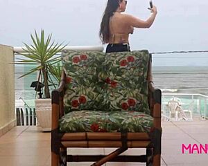 Peeking at Manu Fox fingering her pussy by the beach window!