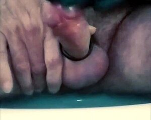 guy strokes stiff cock with tight latex gloves and ring for intense buildup