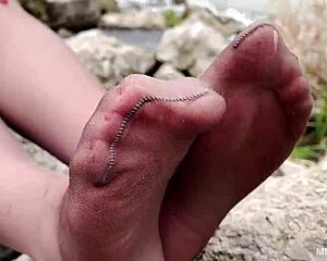 goddess teases feet in tan pantyhose amid spring forest